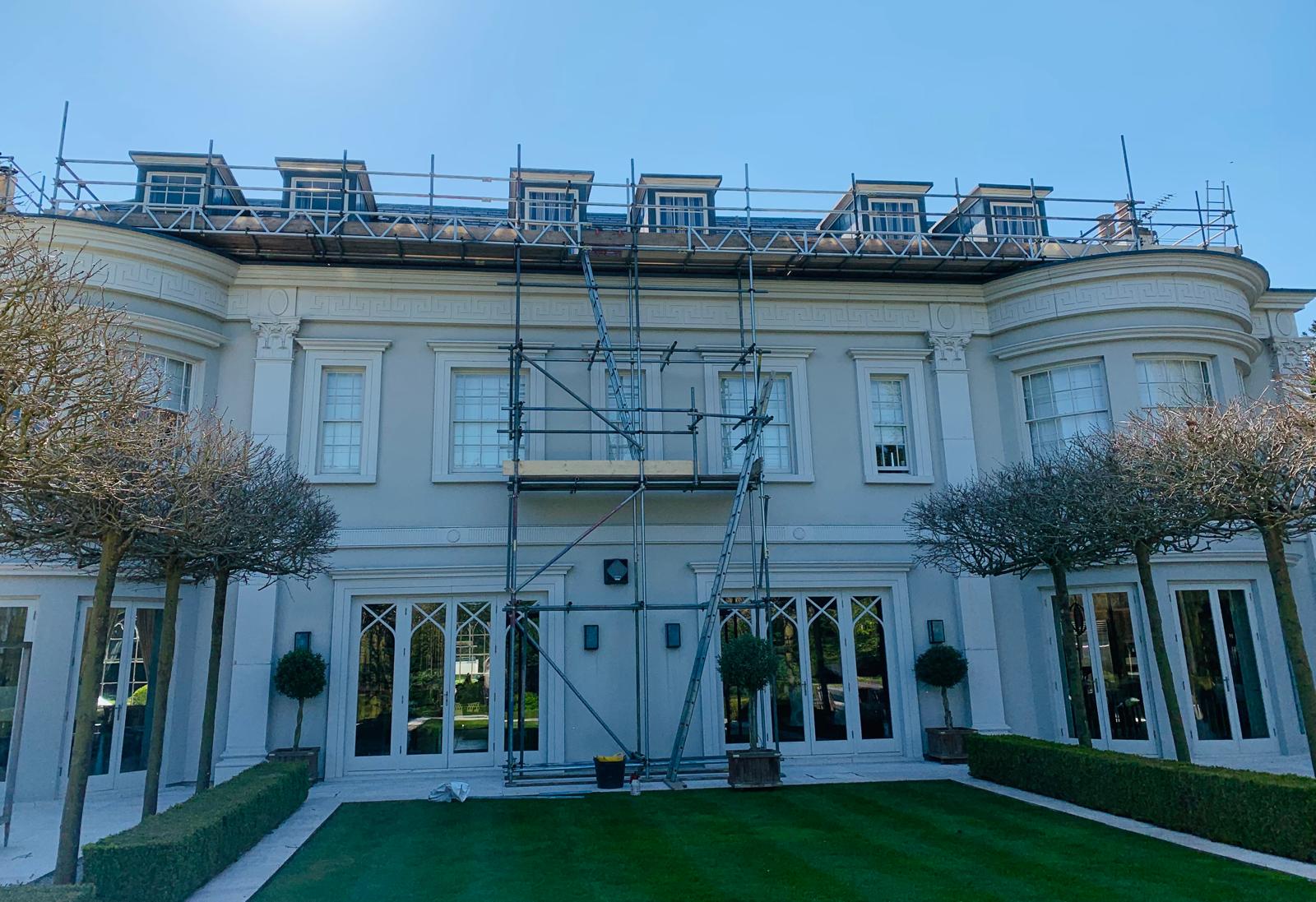 Curved neoclassical manor with dormer scaffold