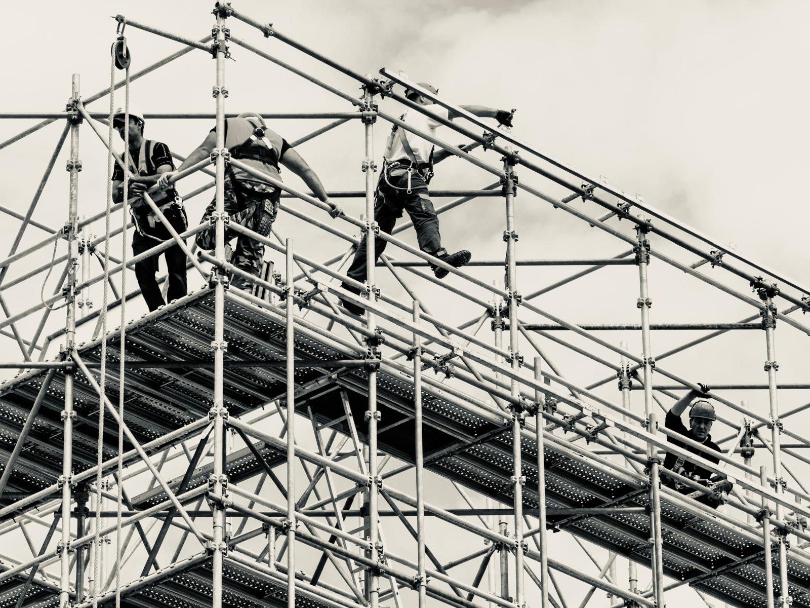 NPS crew erecting scaffold at height, black & white